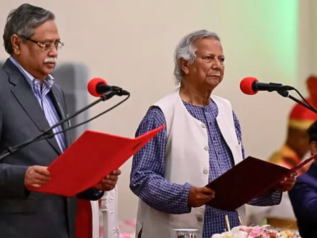 nobel laureate muhammad yunus centre takes the oath of office as the chief adviser of bangladesh s new interim government during a ceremony administered by president mohammed shahabuddin left in dhaka photo afp